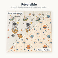 Tapis de jeu réversible astronaute et planètes vu du dessus, coupé en diagonale entre le recto et le verso